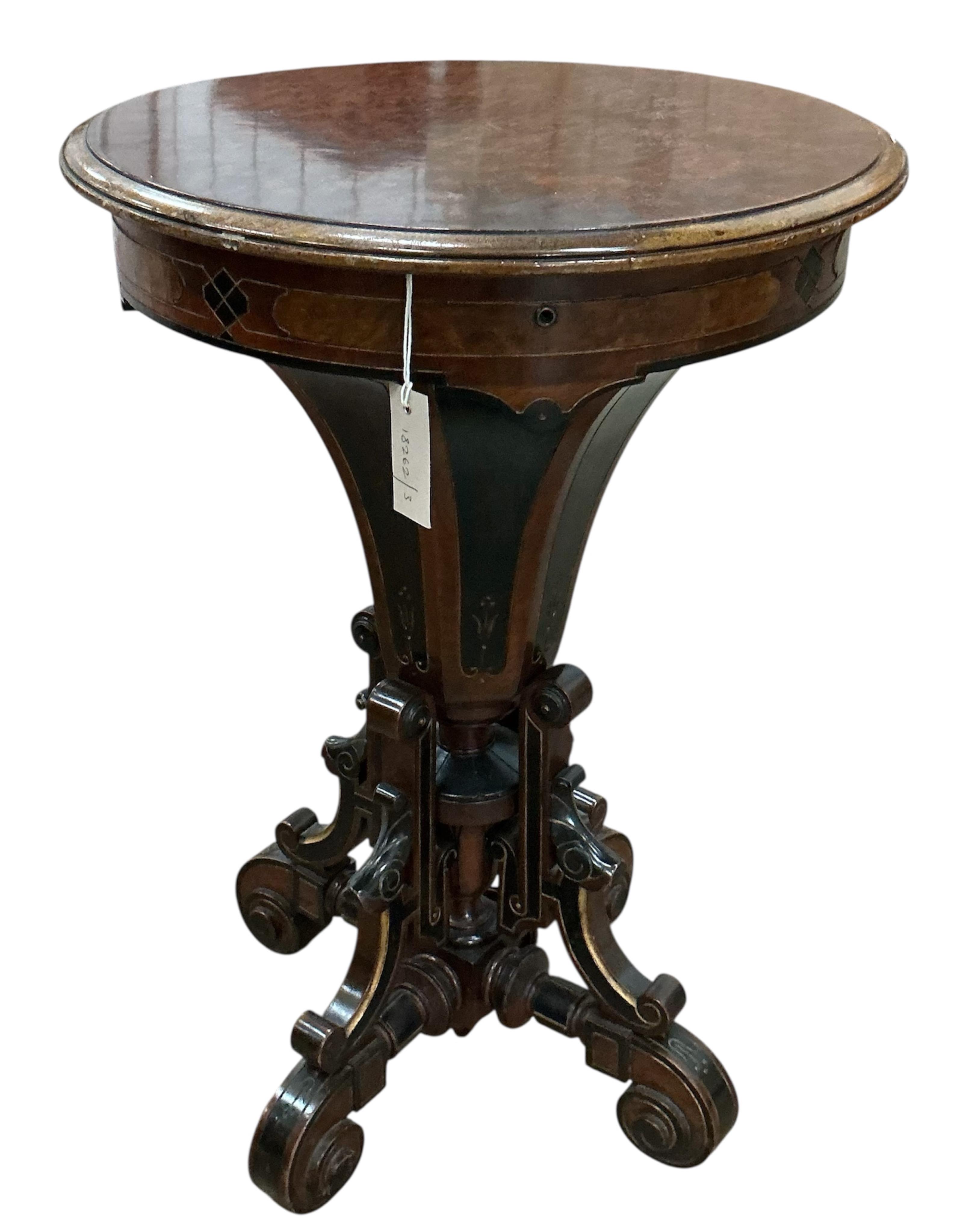 A Victorian circular ebonised amboyna work table, diameter 49cm, height 72cm